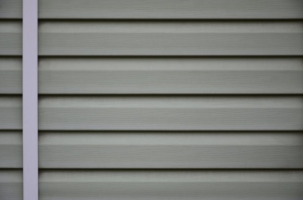 Siding, plastic panels texture closeup in the daytime outdoors